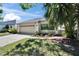 Single-Gathering home with a two-car garage and lush landscaping at 370 S Woodlands Dr, Oldsmar, FL 34677