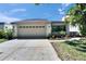 Well-maintained single-Gathering home with a two-car garage and manicured garden at 370 S Woodlands Dr, Oldsmar, FL 34677