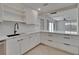 Modern kitchen with white cabinets, sleek countertops, and wood look floors at 370 S Woodlands Dr, Oldsmar, FL 34677