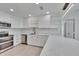 Contemporary kitchen with glossy white cabinets, stylish fixtures and stainless appliances at 370 S Woodlands Dr, Oldsmar, FL 34677