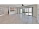 Open-concept living room featuring light wood floors, access to the kitchen, and an outdoor patio at 370 S Woodlands Dr, Oldsmar, FL 34677