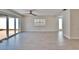 Bright living room with light wood floors, a ceiling fan, and sliding glass doors to the patio at 370 S Woodlands Dr, Oldsmar, FL 34677