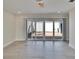 Sunlit living room featuring sliding glass doors to a private patio or courtyard at 370 S Woodlands Dr, Oldsmar, FL 34677