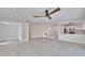 Open floor plan with wood look floors, neutral walls and ceiling fan at 370 S Woodlands Dr, Oldsmar, FL 34677