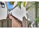 Brick-paved walkway with tropical landscaping and a privacy fence at 370 S Woodlands Dr, Oldsmar, FL 34677