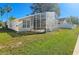 A spacious screened-in patio enhances this home's backyard, with ample green space at 4109 Marlow Loop, Land O Lakes, FL 34639