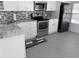 Modern kitchen features stainless steel appliances and grey countertops at 4851 W Gandy Blvd # B1L14, Tampa, FL 33611