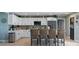 Charming kitchen with white cabinets, a center island with bar seating and stainless steel appliances at 5133 Glenn Dr, New Port Richey, FL 34652