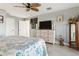 Bedroom with wood-look tile floors and a dresser with a mounted television at 5133 Glenn Dr, New Port Richey, FL 34652