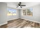 Bright bedroom features light gray walls, natural light and a ceiling fan at 5346 Riddle Rd, Holiday, FL 34690