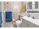 Traditional bathroom with white fixtures, floral wallpaper, and ample lighting for a functional space at 5347 81St N Ln # 25, St Petersburg, FL 33709