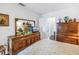 Bright bedroom with a large dresser and mirror, providing ample storage and a view into the next room at 5347 81St N Ln # 25, St Petersburg, FL 33709