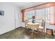 Bright dining area with a table and chairs, located next to a window with natural light and vinyl flooring at 5347 81St N Ln # 25, St Petersburg, FL 33709