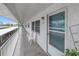 Exterior hallway featuring white chairs and a view of parking at 5347 81St N Ln # 25, St Petersburg, FL 33709