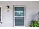 The front door with a storm door on a stucco exterior wall at 5347 81St N Ln # 25, St Petersburg, FL 33709