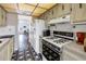 Functional kitchen with dated appliances, patterned floor, and ample storage at 5347 81St N Ln # 25, St Petersburg, FL 33709