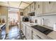 Compact kitchen featuring tile countertops, white appliances, and an eat-in dining area at 5347 81St N Ln # 25, St Petersburg, FL 33709