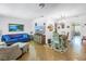 An open-concept living room with dining area featuring a cozy sofa and stylish decor at 5347 81St N Ln # 25, St Petersburg, FL 33709