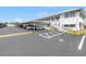 Exterior of condo building with parking lot including covered parking spaces for residents and guests at 5347 81St N Ln # 25, St Petersburg, FL 33709