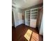 An empty bedroom featuring beautiful hardwood floors and custom built-in shelving at 540 Somerhill Ne Dr, St Petersburg, FL 33716