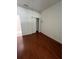 Empty bedroom boasts gleaming hardwood floors and a spacious closet at 540 Somerhill Ne Dr, St Petersburg, FL 33716