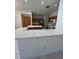 Open kitchen features quartz countertops, island, and wooden cabinets at 540 Somerhill Ne Dr, St Petersburg, FL 33716