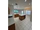 Open kitchen featuring an island, breakfast bar, and tile flooring at 540 Somerhill Ne Dr, St Petersburg, FL 33716