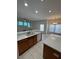 Bright kitchen featuring white countertops, wooden cabinets, and stainless steel appliances overlooking dining area at 540 Somerhill Ne Dr, St Petersburg, FL 33716