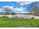 Picturesque view of the neighborhood pond with a well-maintained grassy shoreline enhancing the community's appeal at 540 Somerhill Ne Dr, St Petersburg, FL 33716