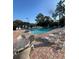 Community pool with lounge chairs and tables on brick paver deck at 540 Somerhill Ne Dr, St Petersburg, FL 33716