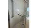 This tiled shower features a built-in niche and grab bar for accessibility at 540 Somerhill Ne Dr, St Petersburg, FL 33716