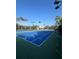 Outdoor tennis courts with blue surface and green trim, palm trees in background at 540 Somerhill Ne Dr, St Petersburg, FL 33716