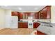 Spacious kitchen featuring wood cabinets, granite countertops, and stainless steel appliances at 5817 Heronpark Pl, Lithia, FL 33547