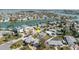 This aerial shot highlights a property with a pool in a waterfront neighborhood; an arrow shows the proximity to canals and homes at 596 S Bayshore Dr, Madeira Beach, FL 33708