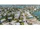 Aerial capture displaying waterfront houses, canals, and proximity to the ocean and coastline at 596 S Bayshore Dr, Madeira Beach, FL 33708