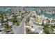 An aerial view shows a home with a pool, indicated by an arrow, in a neighborhood near a body of water and a main road at 596 S Bayshore Dr, Madeira Beach, FL 33708