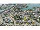 Aerial view featuring a property identified by an arrow, situated in a neighborhood near winding waterways and various residences at 596 S Bayshore Dr, Madeira Beach, FL 33708