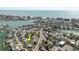 Aerial shot marks a property with an arrow; located in a coastal community, complete with waterfront homes and city views at 596 S Bayshore Dr, Madeira Beach, FL 33708