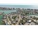 Aerial view displaying properties nestled among canals with convenient access to the open ocean at 596 S Bayshore Dr, Madeira Beach, FL 33708