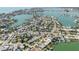 Expansive aerial view of a waterfront community with lush landscapes, private docks, and serene water views at 596 S Bayshore Dr, Madeira Beach, FL 33708