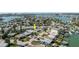 An aerial view shows a property near the water; an arrow marks the location amid homes and boating access in a coastal community at 596 S Bayshore Dr, Madeira Beach, FL 33708