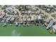 Aerial view of waterfront homes, each featuring private docks and boat access, reflecting a boater's paradise at 596 S Bayshore Dr, Madeira Beach, FL 33708