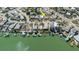 Aerial view of the home located in a waterfront community with boat docks at 596 S Bayshore Dr, Madeira Beach, FL 33708