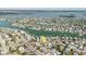 Overhead shot with arrow, directs attention to a house with a pool, nestled among lush landscaping and neighboring houses at 596 S Bayshore Dr, Madeira Beach, FL 33708