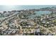High angle aerial shot of a beautiful neighborhood surrounded by canals with mature trees and stunning water views at 596 S Bayshore Dr, Madeira Beach, FL 33708