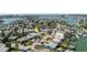An aerial view showcases a property with nearby boating and water access, identified with an arrow, in a coastal residential area at 596 S Bayshore Dr, Madeira Beach, FL 33708