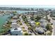 Aerial showcases a home with pool in a waterfront community; an arrow marks the property's location near a waterway and city skyline at 596 S Bayshore Dr, Madeira Beach, FL 33708