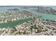 Panoramic aerial view of a waterfront neighborhood with canals and luxurious homes, showcasing a desirable coastal lifestyle at 596 S Bayshore Dr, Madeira Beach, FL 33708