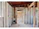 Hallway featuring unfinished walls and floor ready for renovation at 596 S Bayshore Dr, Madeira Beach, FL 33708
