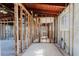Hallway featuring wood ceiling with white tile floor offering renovation potential at 596 S Bayshore Dr, Madeira Beach, FL 33708
